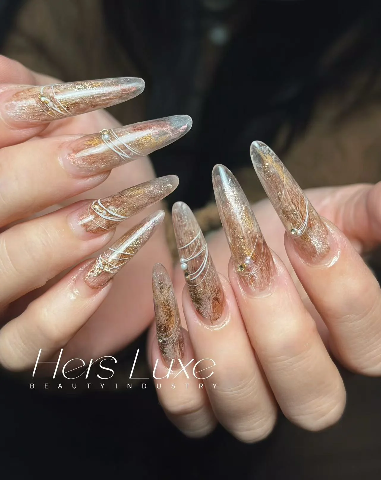 Hers Luxe nail art — amber gold-leaf stiletto set